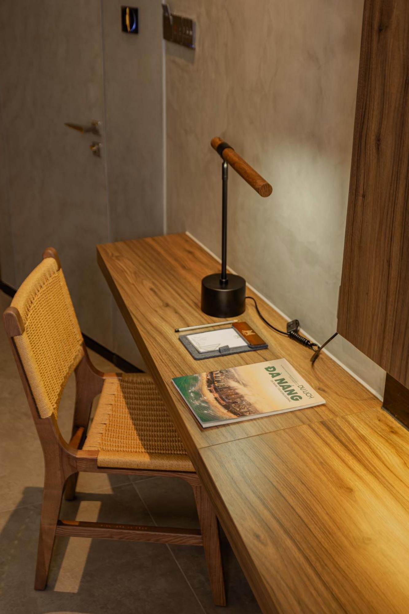 M Hotel Danang Bagian luar foto A desk with a magazine on it